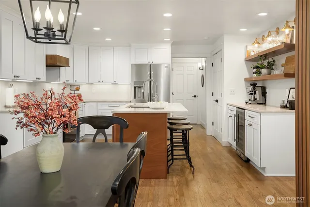 a large kitchen with a table and chairs