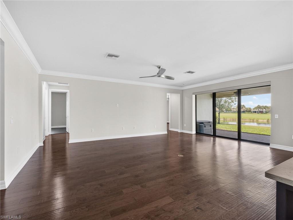 6124 Victory Drive Ave Maria, FL 34142 - Photo 17 of 50 a view of an empty room with wooden floor and a window