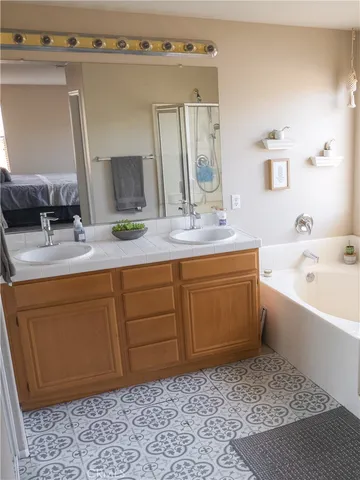 a bathroom with a tub sink and mirror