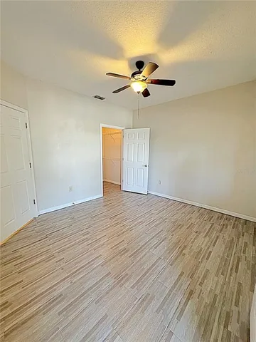 a view of a room with wooden floor