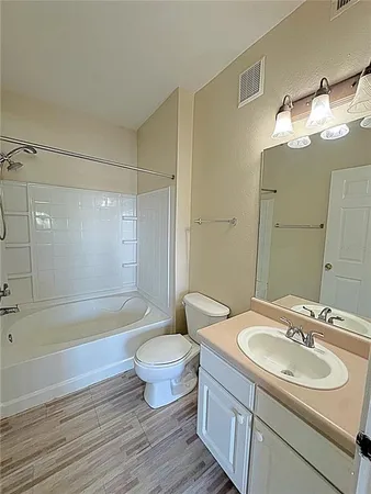 a bathroom with a sink toilet a mirror and shower