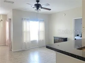 a kitchen with stainless steel appliances granite countertop a sink a stove and a wooden floors