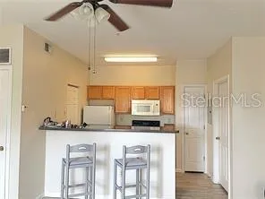a kitchen with stainless steel appliances a sink cabinets and wooden floor