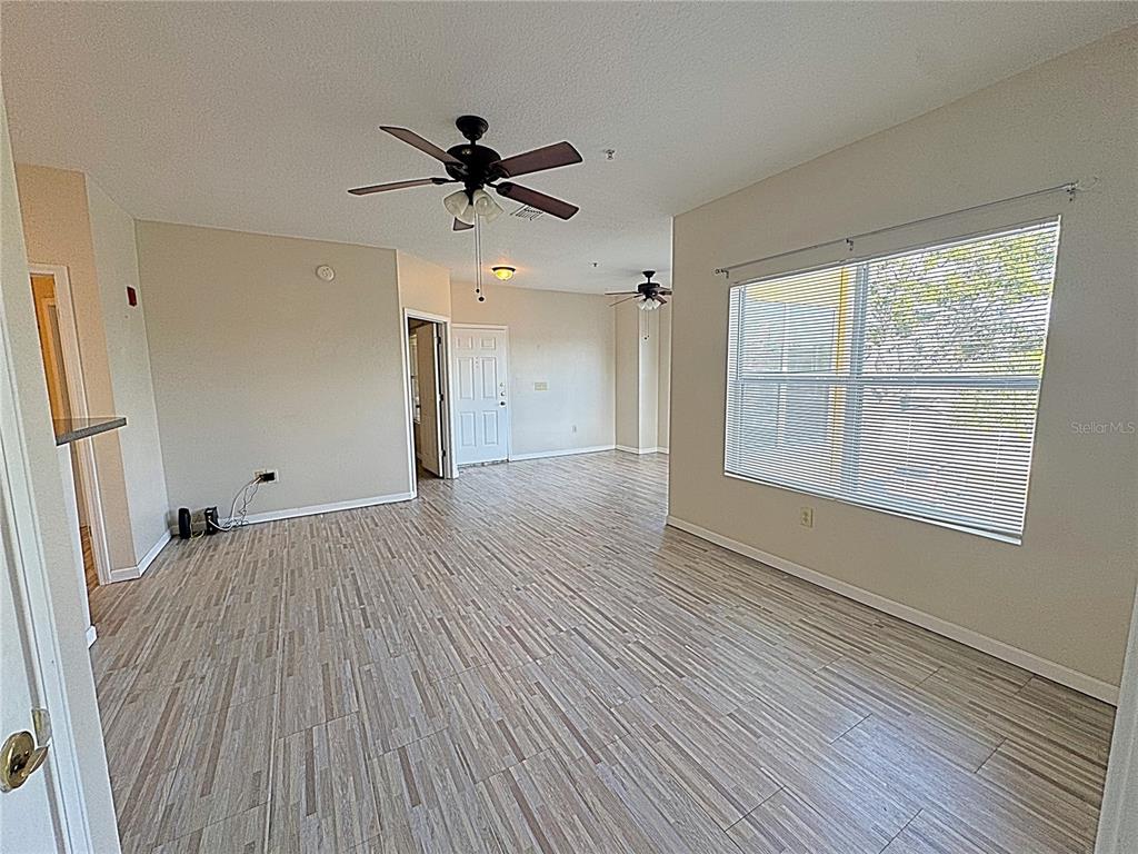 10764 70th Avenue, Unit 8201 Seminole, FL 33772 - Photo 5 of 37 wooden floor in an empty room with a window