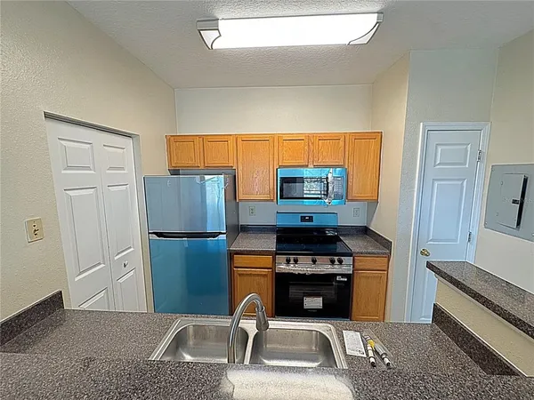 a kitchen with stainless steel appliances a stove a sink and a refrigerator