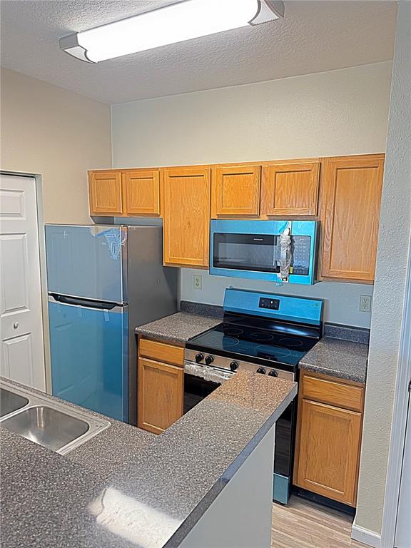 10764 70th Avenue, Unit 8201 Seminole, FL 33772 - Photo 7 of 37 a kitchen with stainless steel appliances granite countertop a stove a refrigerator and a sink