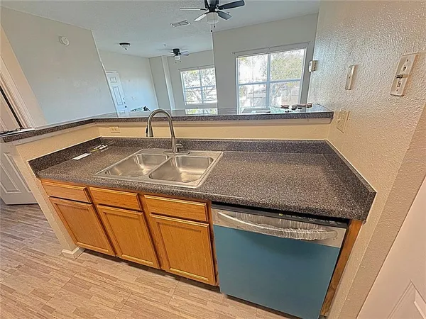 a kitchen with granite countertop a sink and a stove top oven