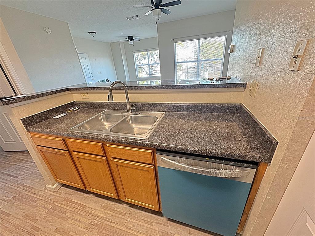 10764 70th Avenue, Unit 8201 Seminole, FL 33772 - Photo 8 of 37 a kitchen with granite countertop a sink and a stove top oven