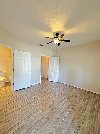a view of an empty room and wooden floor