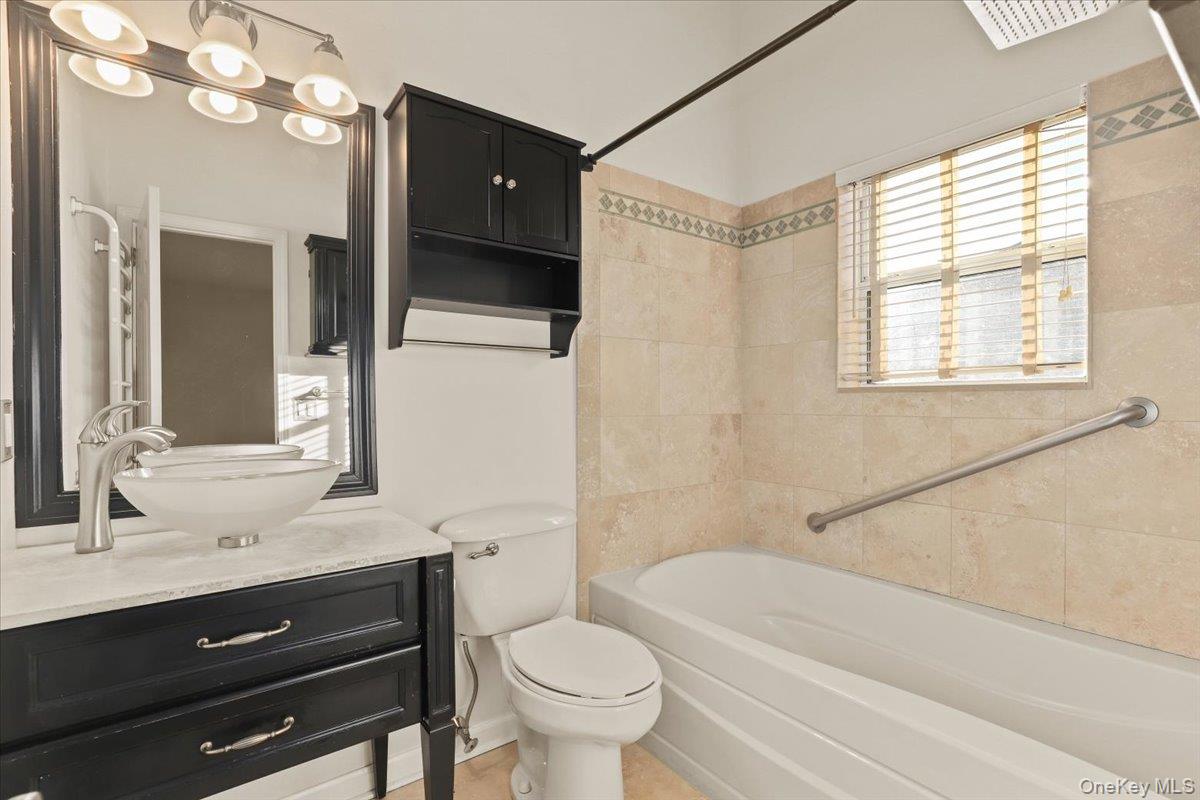 51 Hemlock Circle Peekskill, NY 10566 - Photo 12 of 21 a bathroom with a sink a toilet a mirror and shower