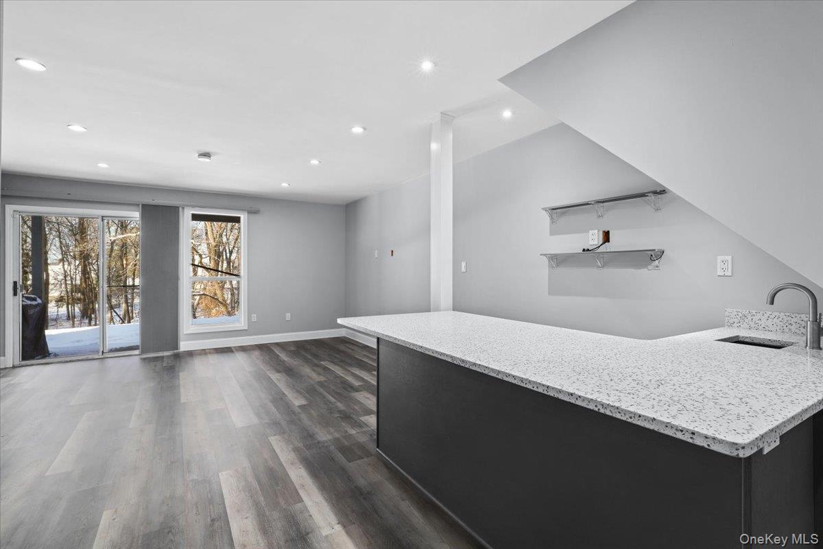 51 Hemlock Circle Peekskill, NY 10566 - Photo 15 of 21 a kitchen with a sink a wooden floor and a large window
