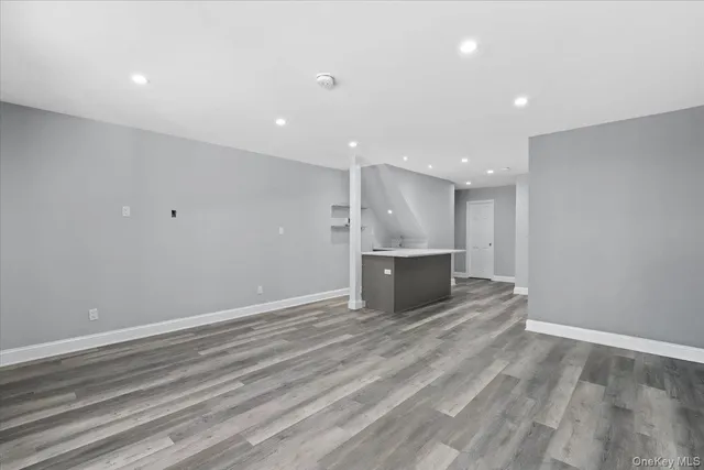 a view of kitchen with kitchen island microwave and stove