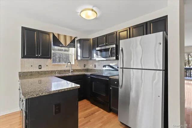 a kitchen with a refrigerator sink and microwave