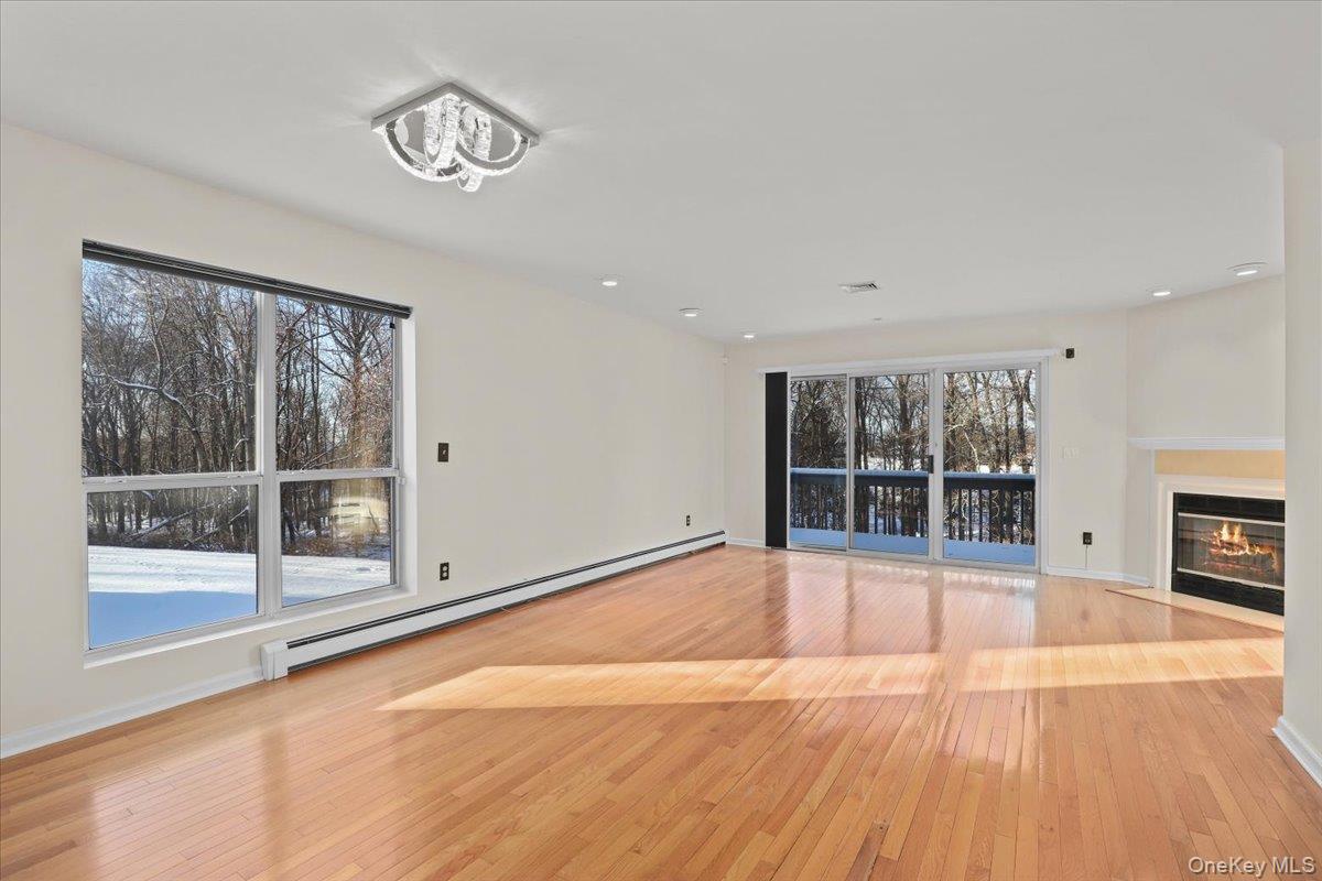 51 Hemlock Circle Peekskill, NY 10566 - Photo 6 of 21 a view of an empty room with wooden floor and a window