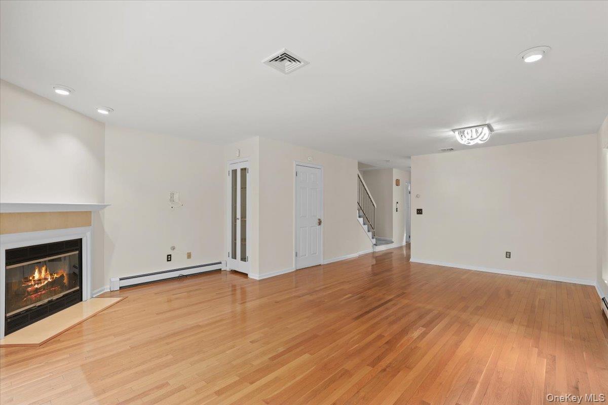 51 Hemlock Circle Peekskill, NY 10566 - Photo 8 of 21 a view of an empty room with wooden floor and a fireplace
