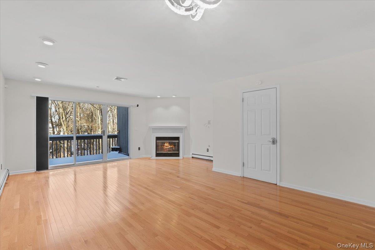 51 Hemlock Circle Peekskill, NY 10566 - Photo 9 of 21 a view of an empty room with wooden floor and a window