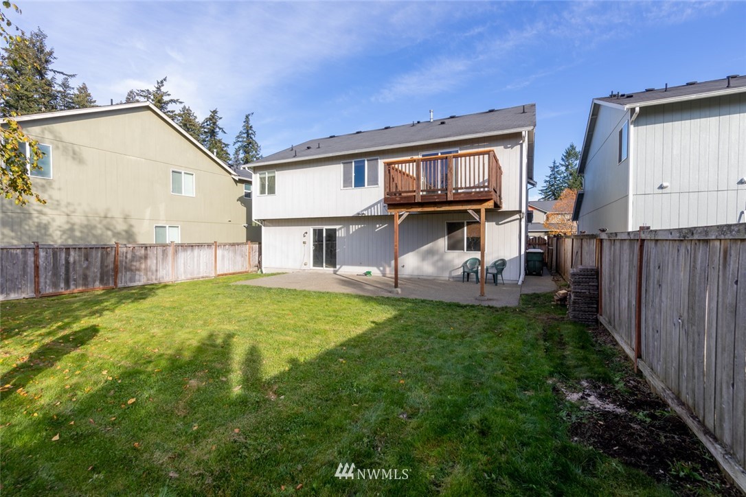 8317 49th Loop Southeast Olympia, WA 98513 - Photo 22 of 25 a view of a house with backyard and sitting area