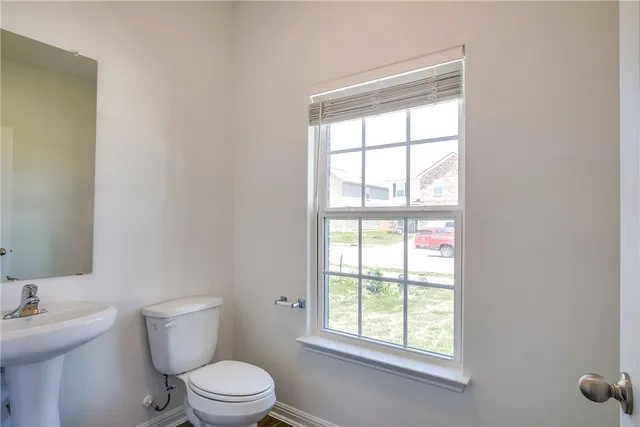 a white toilet sitting next to a bathroom sink