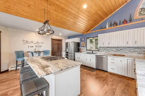 a kitchen with stainless steel appliances granite countertop a sink and cabinets