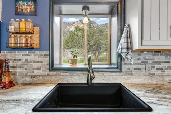 a kitchen with granite countertop a sink and a window