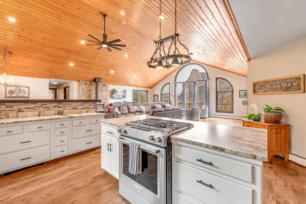 a kitchen with stainless steel appliances granite countertop a stove and cabinets