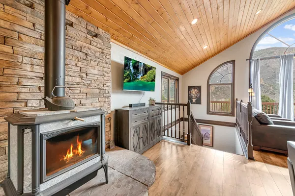 a view of living room kitchen with furniture and fireplace