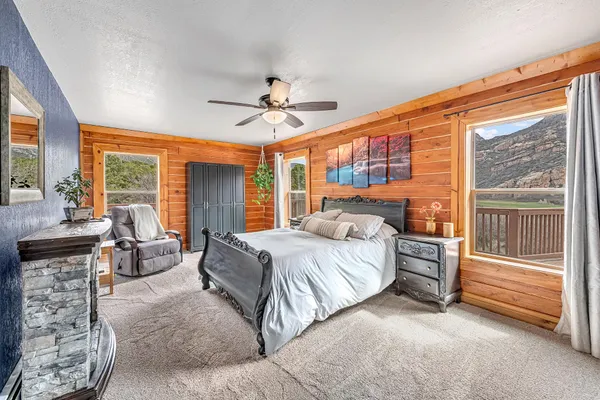 a spacious bedroom with a large bed and windows