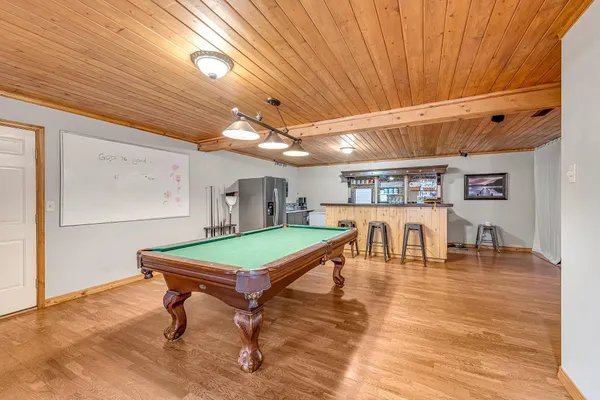 a room with furniture and pool table