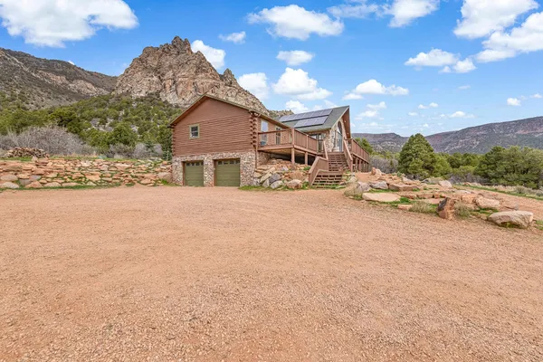 a view of a house with a snow yard and mountain view
