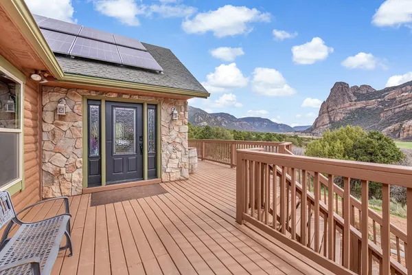 a view of a balcony with wooden floor and city view