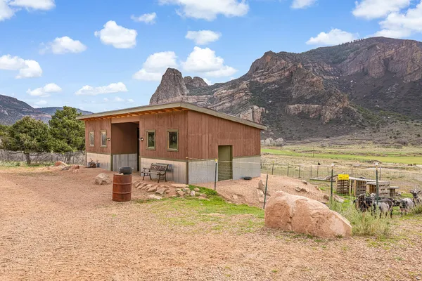 a backyard of a house with table and chairs