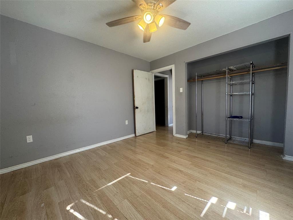 3520 Colcord Avenue Waco, TX 76707 - Photo 13 of 17 Unfurnished bedroom with light wood-style flooring, a closet, and a ceiling fan