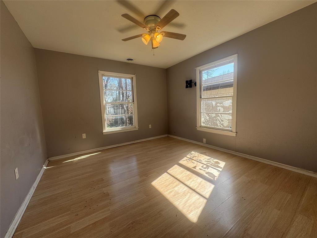 3520 Colcord Avenue Waco, TX 76707 - Photo 14 of 17 Unfurnished room featuring light wood-style floors and ceiling fan