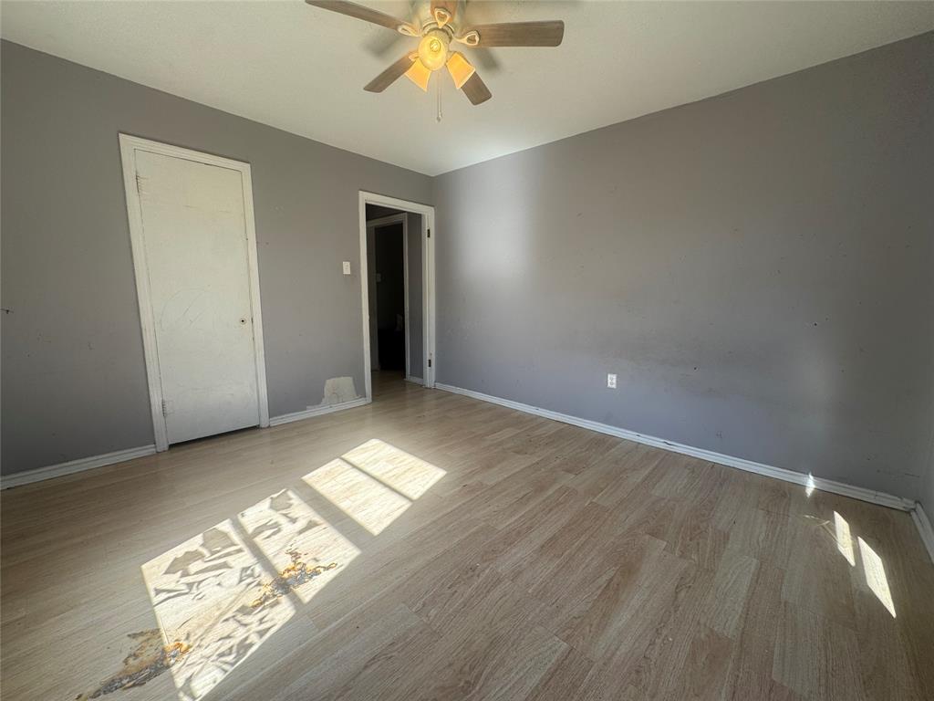 3520 Colcord Avenue Waco, TX 76707 - Photo 15 of 17 Unfurnished bedroom with light wood finished floors and a ceiling fan