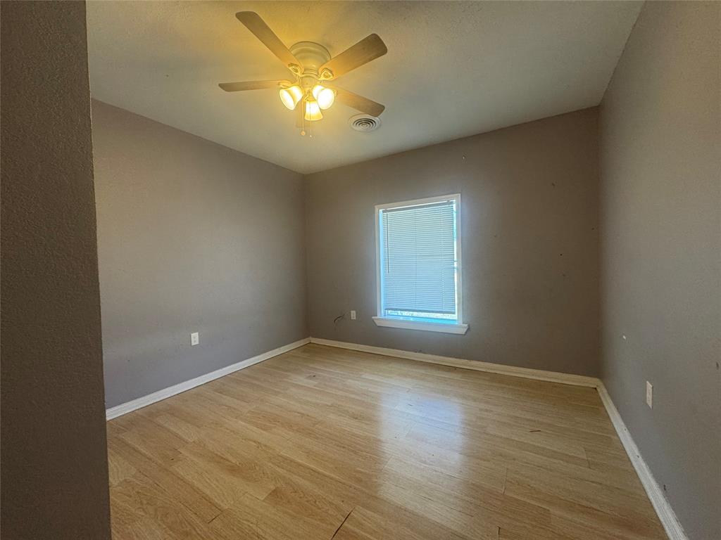 3520 Colcord Avenue Waco, TX 76707 - Photo 7 of 17 Spare room with light wood finished floors and ceiling fan