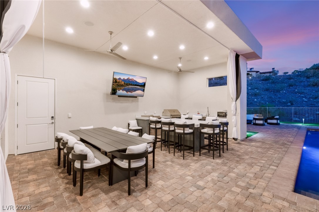 5 Crystal Tree Pass Henderson, NV 89052 - Photo 57 of 67 An inviting outdoor living area for entertainment with a fully equipped kitchen, dining space, and a pool.