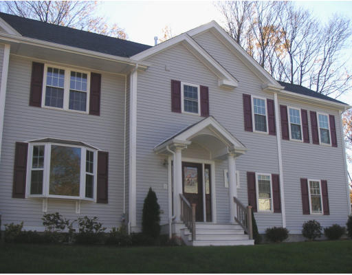 27 Hartwell Place Canton, MA 02021 - Photo 1 of 12 a front view of a house with a yard