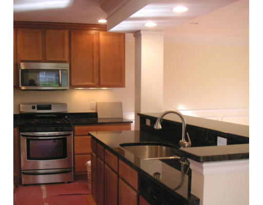 27 Hartwell Place Canton, MA 02021 - Photo 2 of 12 a kitchen with stainless steel appliances granite countertop a sink stove and microwave