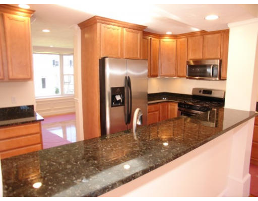 27 Hartwell Place Canton, MA 02021 - Photo 3 of 12 a kitchen with stainless steel appliances granite countertop a refrigerator a stove and a sink with wooden floor