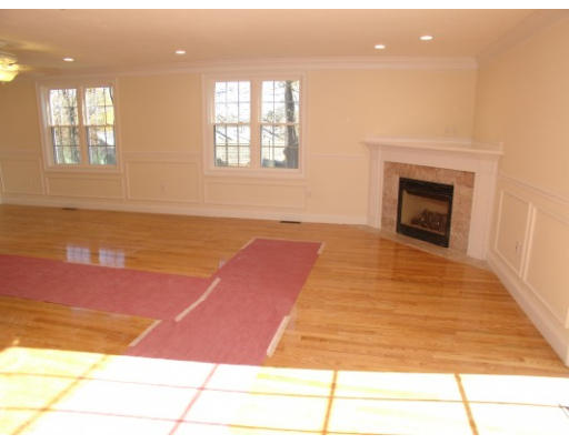 27 Hartwell Place Canton, MA 02021 - Photo 4 of 12 a view of empty room with wooden floor and fan