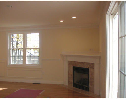 27 Hartwell Place Canton, MA 02021 - Photo 5 of 12 a view of an empty room with a fireplace and a window