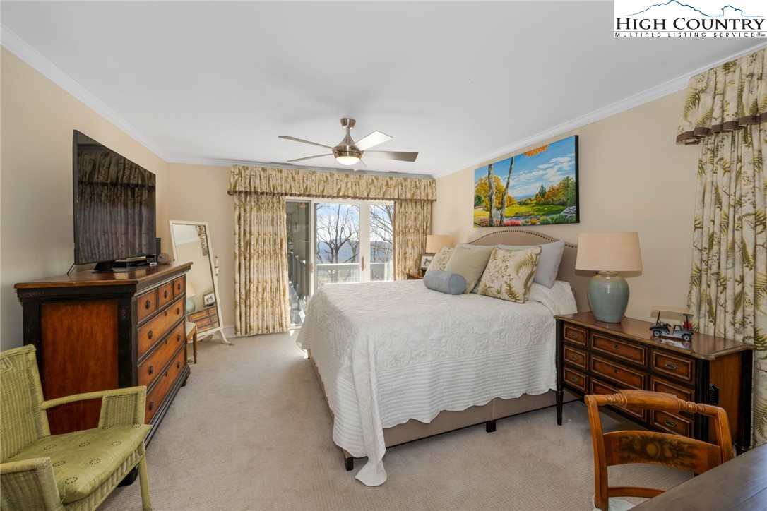 404 Moon Run, Unit D Linville, NC 28646 - Photo 14 of 27 a spacious bedroom with a bed and a flat screen tv