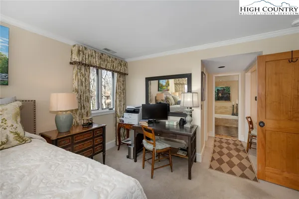 a bedroom with a bed and a desk in it