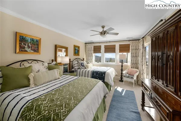 a bedroom with two beds and a large window