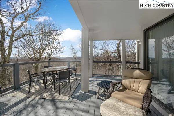 a work room with furniture and large windows