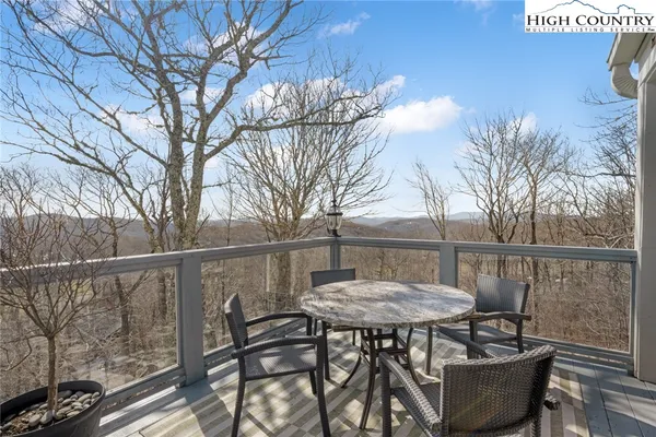 a view of a chairs and table in the balcony