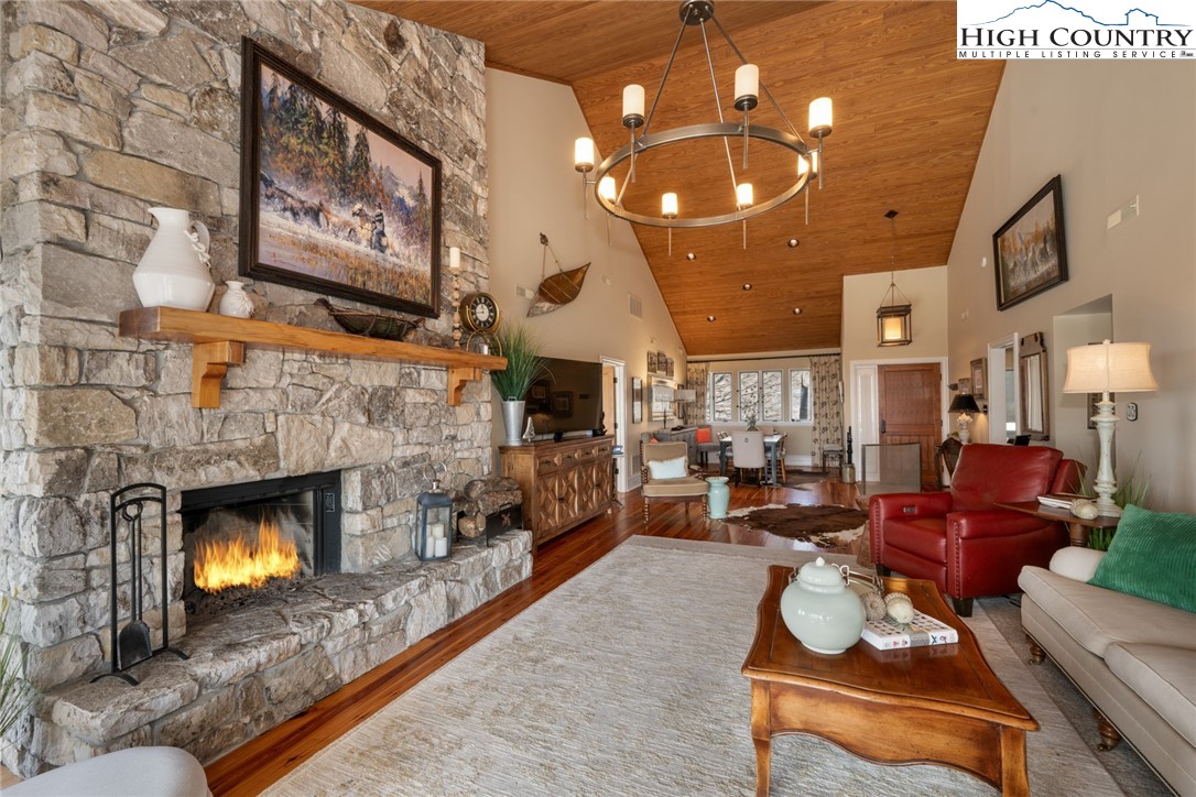 404 Moon Run, Unit D Linville, NC 28646 - Photo 4 of 27 a living room with furniture a fireplace and a chandelier