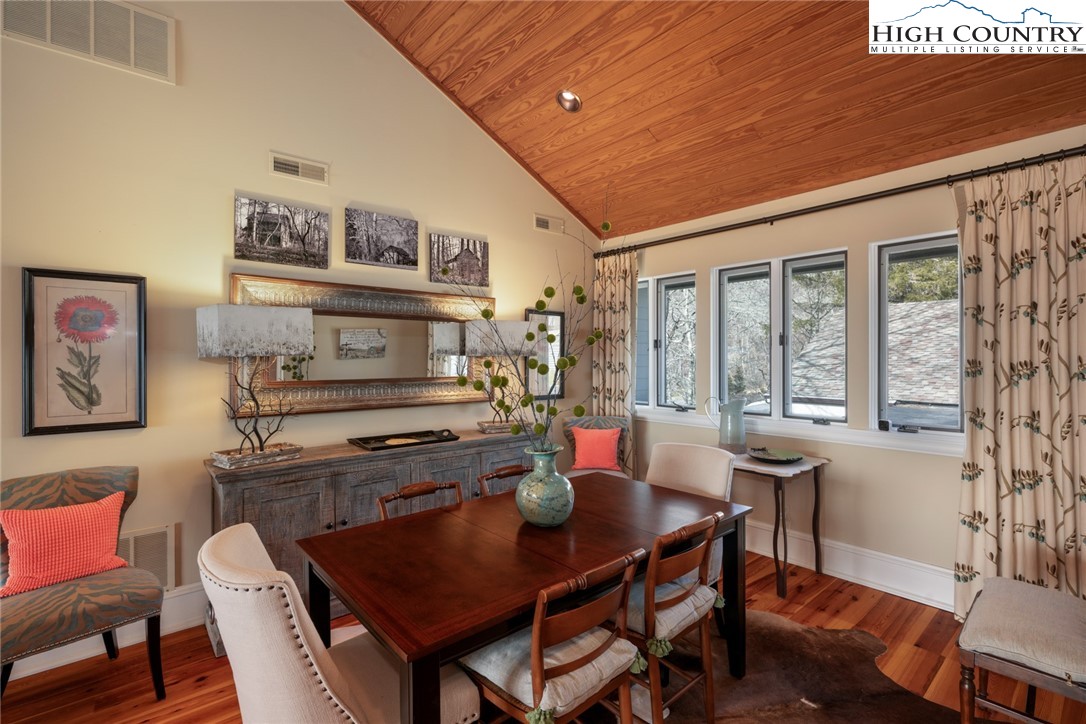 404 Moon Run, Unit D Linville, NC 28646 - Photo 9 of 27 a view of a dining room with furniture window and wooden floor