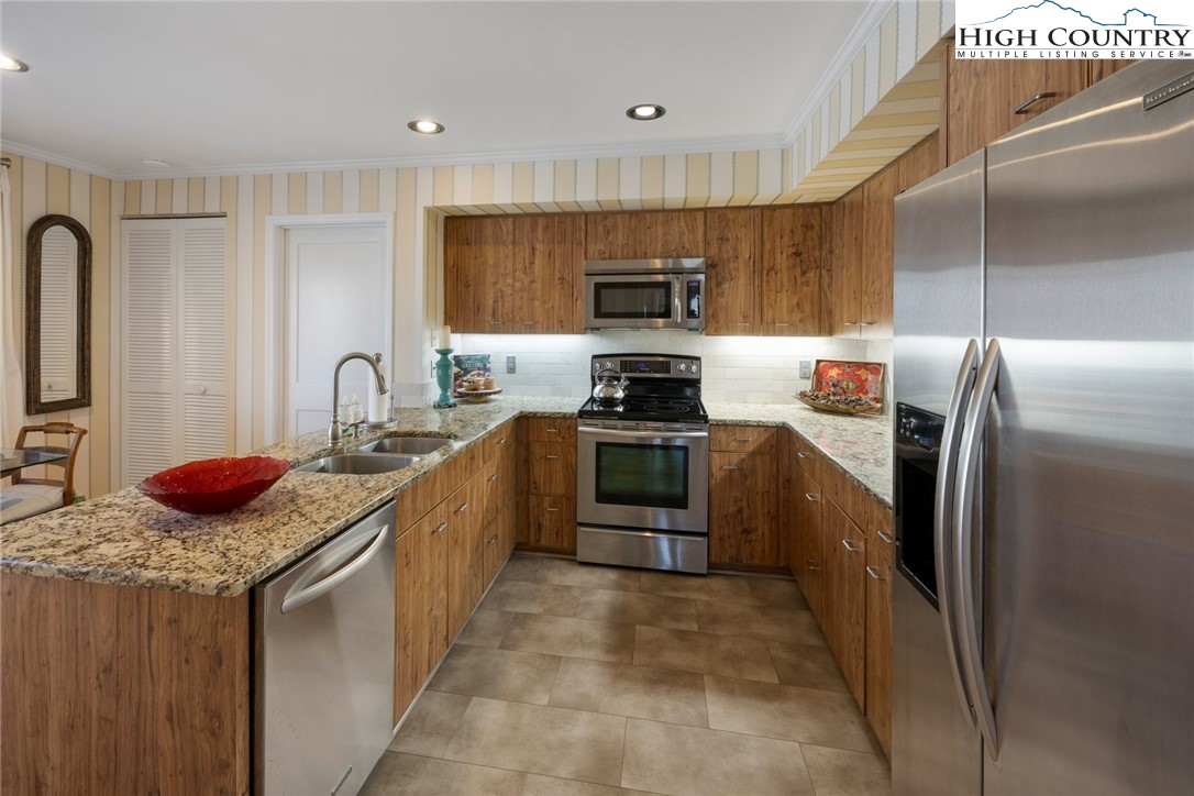 404 Moon Run, Unit D Linville, NC 28646 - Photo 10 of 27 a kitchen with stainless steel appliances a refrigerator sink and stove
