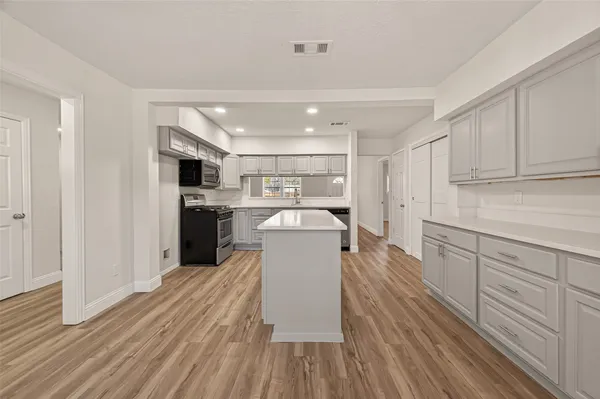 a kitchen with a refrigerator and a sink